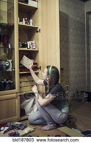 Caucasian girl replacing picture frames View Large Photo Image Stock Image - Caucasian girl replacing picture frames. Fotosearch