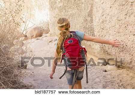 Caucasian girl touching rock formation View Large Photo Image Stock Photo - Caucasian girl touching rock formation. Fotosearch