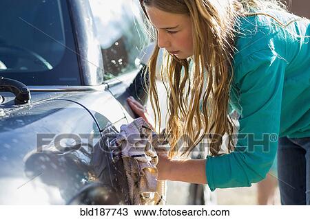 Stock Image - Caucasian girl washing car. Fotosearch