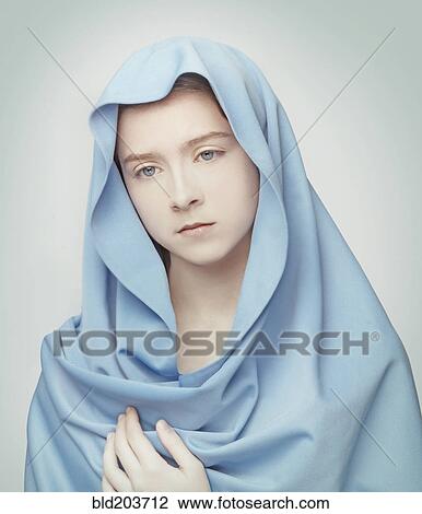 Stock Image - Caucasian girl wrapped in blanket. Fotosearch