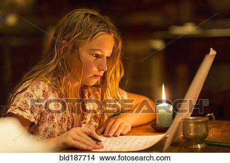 Caucasian girl writing by candle light View Large Photo Image Picture - Caucasian girl writing by candle light. Fotosearch