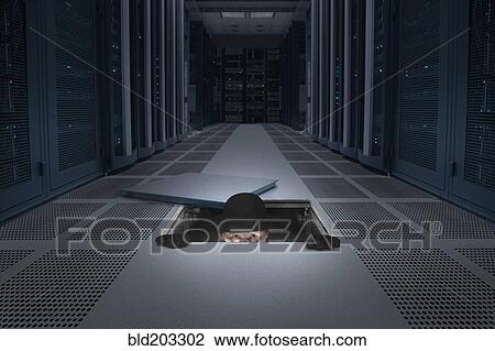 Stock Image - Caucasian man climbing into air vent. Fotosearch