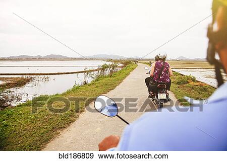Caucasian man driving scooter in rural landscape View Large Photo Image Stock Photo - Caucasian man driving scooter in rural landscape. Fotosearch