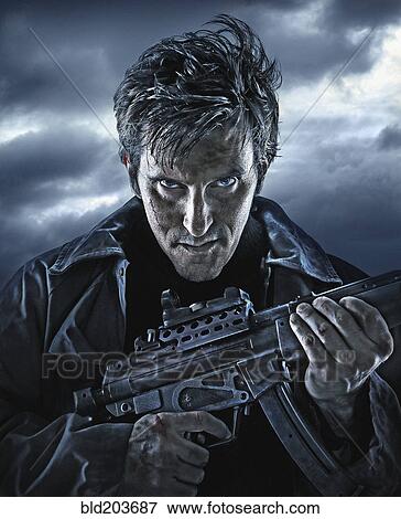 Caucasian man holding machine gun outdoors View Large Photo Image Stock Photo - Caucasian man holding machine gun outdoors. Fotosearch