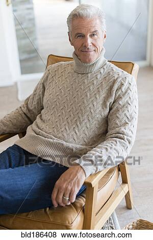 Caucasian man sitting in armchair View Large Photo Image Stock Photo - Caucasian man sitting in armchair. Fotosearch
