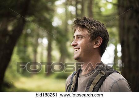 Caucasian man smiling in forest View Large Photo Image Stock Image - Caucasian man smiling in forest. Fotosearch