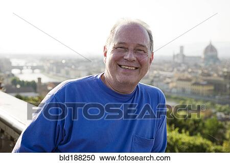Stock Image - Caucasian man smiling outdoors. Fotosearch