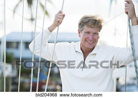 Stock Photo - Caucasian man smiling outdoors. Fotosearch