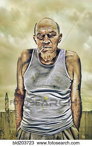 Stock Image - Caucasian man smoking outdoors. Fotosearch