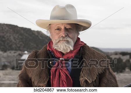 Caucasian man standing in dusty landscape View Large Photo Image Stock Photo - Caucasian man standing in dusty landscape. Fotosearch