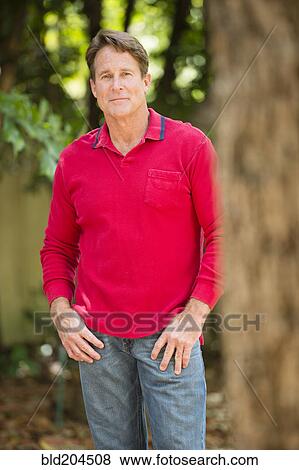 Stock Photo - Caucasian man standing in park. Fotosearch