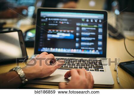 Stock Photo - Caucasian man using laptop. Fotosearch