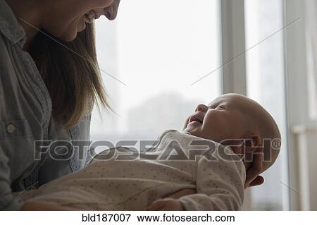 Caucasian mother admiring baby View Large Photo Image Stock Photo - Caucasian mother admiring baby. Fotosearch