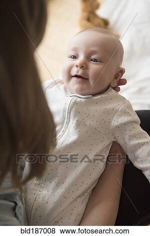 Stock Photo - Caucasian mother admiring baby. Fotosearch