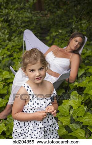 Stock Photography - Caucasian mother and daughter in garden. Fotosearch