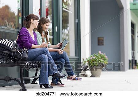 Caucasian mother and daughter using tablet together View Large Photo Image Stock Image - Caucasian mother and daughter using tablet together. Fotosearch