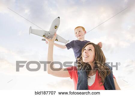 Caucasian mother and son flying toy airplane View Large Photo Image Stock Photo - Caucasian mother and son flying toy airplane. Fotosearch