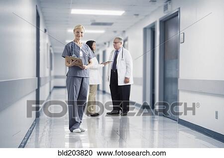 Stock Image - Caucasian nurse smiling in hospital. Fotosearch