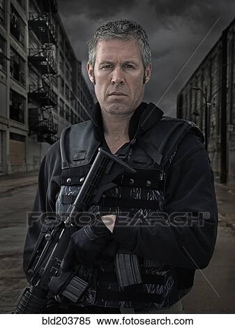 Stock Photography - Caucasian policeman on city street. Fotosearch