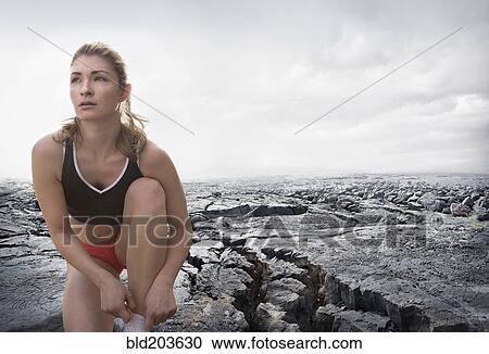 Caucasian runner tying shoes on rock formation View Large Photo Image Stock Image - Caucasian runner tying shoes on rock formation. Fotosearch