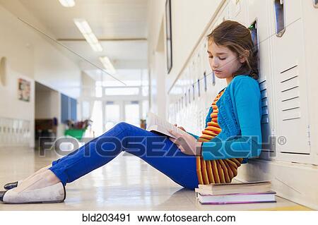 Caucasian student reading in school hallway View Large Photo Image Stock Image - Caucasian student reading in school hallway. Fotosearch