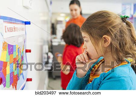 Caucasian student reading map in classroom View Large Photo Image Stock Photo - Caucasian student reading map in classroom. Fotosearch