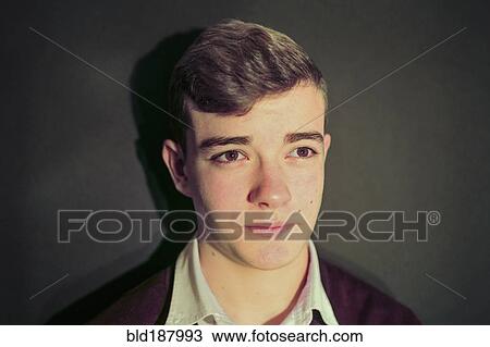 Stock Image - Caucasian teenage boy with serious expression. Fotosearch