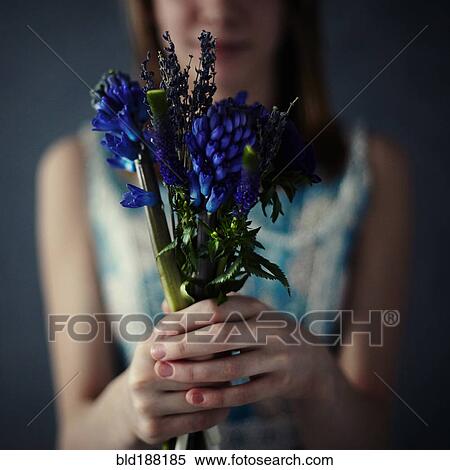 Stock Photography - Caucasian teenage girl holding bouquet of flowers. Fotosearch