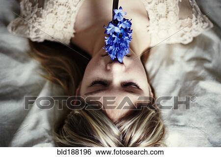 Caucasian teenage girl smelling flower View Large Photo Image Stock Photograph - Caucasian teenage girl smelling flower. Fotosearch