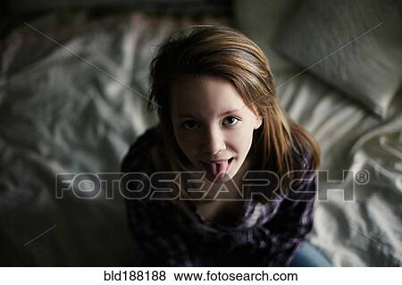 Stock Photo - Caucasian teenage girl sticking out tongue. Fotosearch