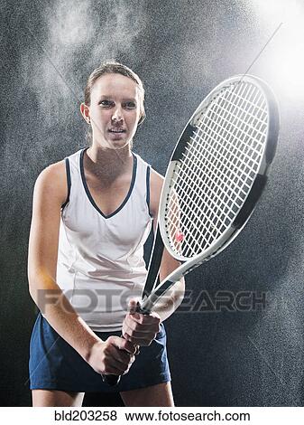 Stock Photo - Caucasian tennis player in rain. Fotosearch