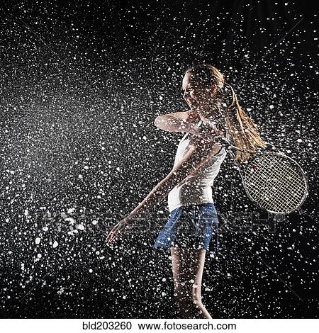 Stock Image - Caucasian tennis player splashing in water. Fotosearch