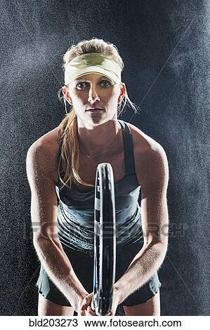 Caucasian tennis player standing in rain View Large Photo Image Stock Image - Caucasian tennis player standing in rain. Fotosearch