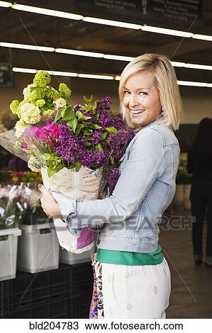 Caucasian woman carrying bouquet of flowers View Large Photo Image Stock Image - Caucasian woman carrying bouquet of flowers. Fotosearch