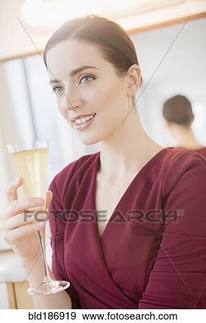 Caucasian woman drinking glass of champagne View Large Photo Image Stock Photo - Caucasian woman drinking glass of champagne. Fotosearch