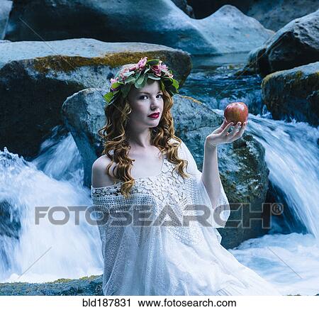 Caucasian woman holding apple at river waterfall View Large Photo Image Stock Image - Caucasian woman holding apple at river waterfall. Fotosearch