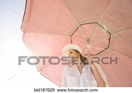 Caucasian woman holding umbrella View Large Photo Image Stock Photo - Caucasian woman holding umbrella. Fotosearch