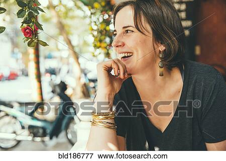 Stock Photo - Caucasian woman laughing outdoors. Fotosearch