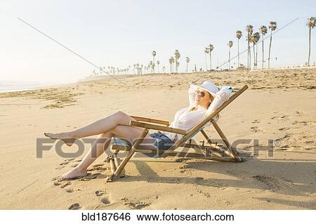 Caucasian woman laying on beach View Large Photo Image Stock Photograph - Caucasian woman laying on beach. Fotosearch