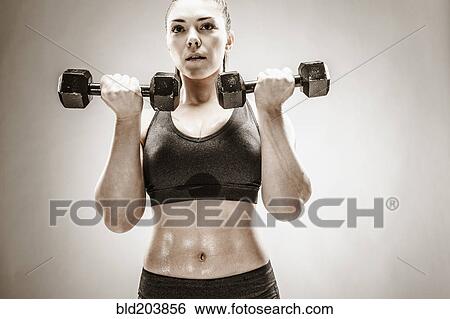 Stock Photograph - Caucasian woman lifting weights. Fotosearch