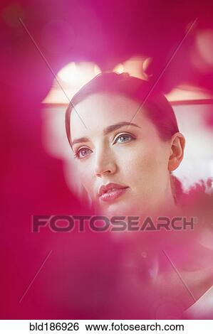 Stock Photograph - Caucasian woman obscured by flowers. Fotosearch