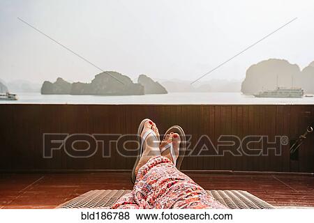 Stock Photo - Caucasian woman on boat in Ha Long Bay, Vietnam. Fotosearch