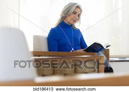 Caucasian woman reading book in armchair View Large Photo Image Stock Image - Caucasian woman reading book in armchair. Fotosearch