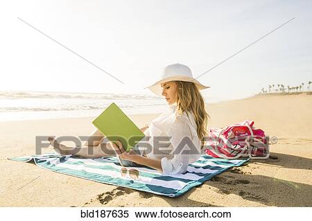 Caucasian woman reading book on beach View Large Photo Image Stock Photography - Caucasian woman reading book on beach. Fotosearch