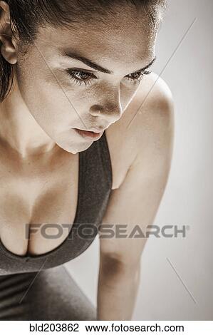 Stock Image - Caucasian woman resting after workout. Fotosearch