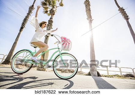 Caucasian woman riding bicycle View Large Photo Image Stock Image - Caucasian woman riding bicycle. Fotosearch