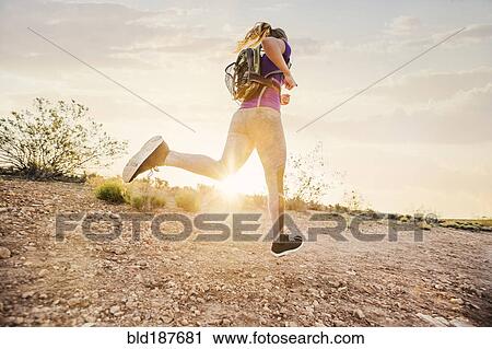 Caucasian woman running on remote hilltop View Large Photo Image Stock Image - Caucasian woman running on remote hilltop. Fotosearch