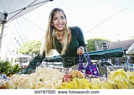 Caucasian woman shopping in flower market View Large Photo Image Stock Image - Caucasian woman shopping in flower market. Fotosearch