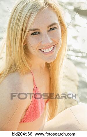 Stock Photograph - Caucasian woman smiling at beach. Fotosearch