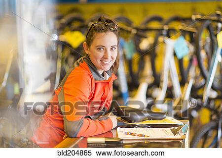 Caucasian woman smiling in bicycle shop View Large Photo Image Stock Photography - Caucasian woman smiling in bicycle shop. Fotosearch